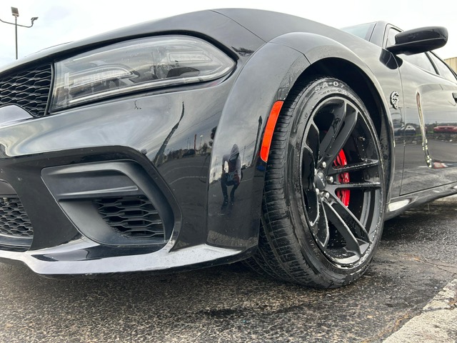 Black Dodge Charger Hellcat with freshly cleaned wheels and paint